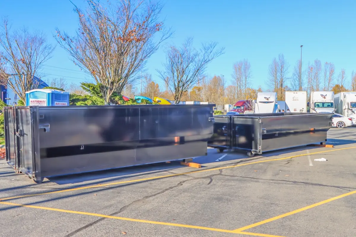 Professional dumpster rental service with roll-off container on residential driveway in Wolfeboro